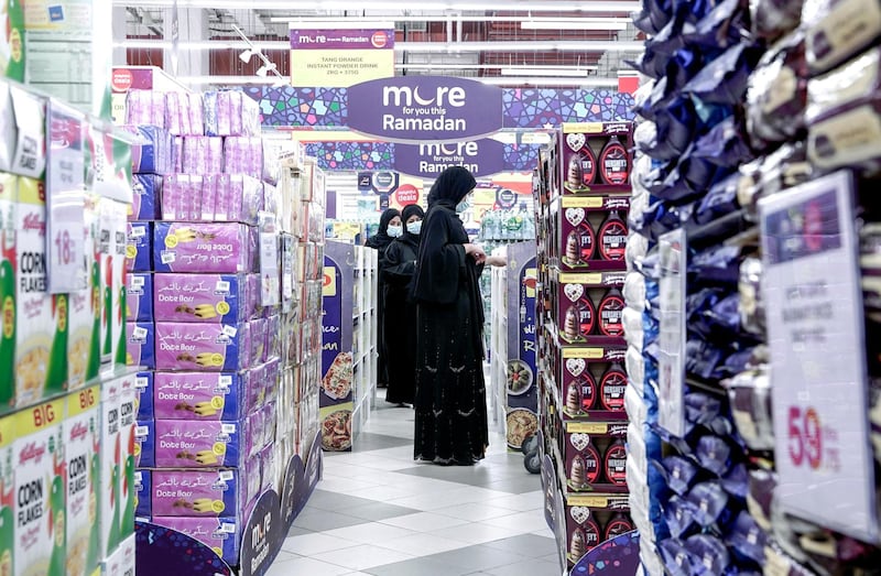 Abu Dhabi, United Arab Emirates, April 21, 2020. 
  Early Ramadan shoppers at Carrefour Yas Mall.  A lady checks out a Ramadan promotional stand.
Victor Besa / The National
Section:  NA
For:  Stock images