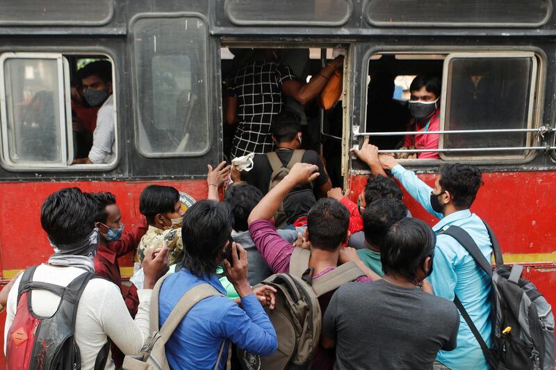 People scramble to board a bus in Mumbai, India. Reuters