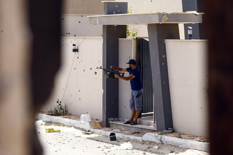 A fighters loyal to the internationally recognised Libyan Government of National Accord (GNA) shoots fires his rifle during clashes with forces loyal to strongman Khalifa Haftar in the capital Tripoli's suburb of Ain Zara.  AFP