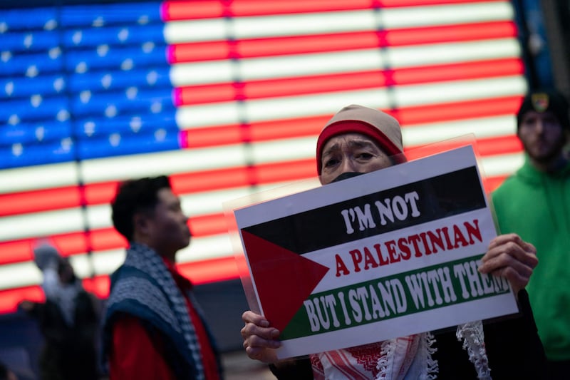 A person holds a sign in support of the Palestinian people in Times Square in New York. Getty Images