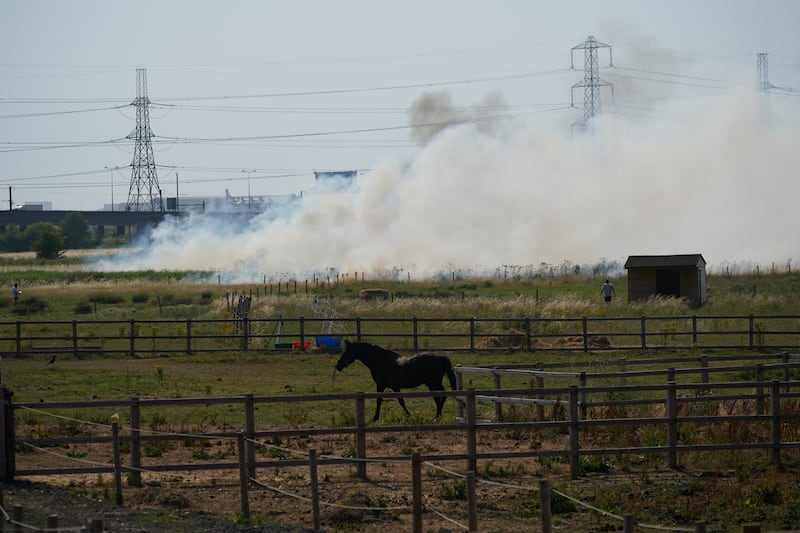 Smoke pours from a blaze in the village of Wennington, east London. PA