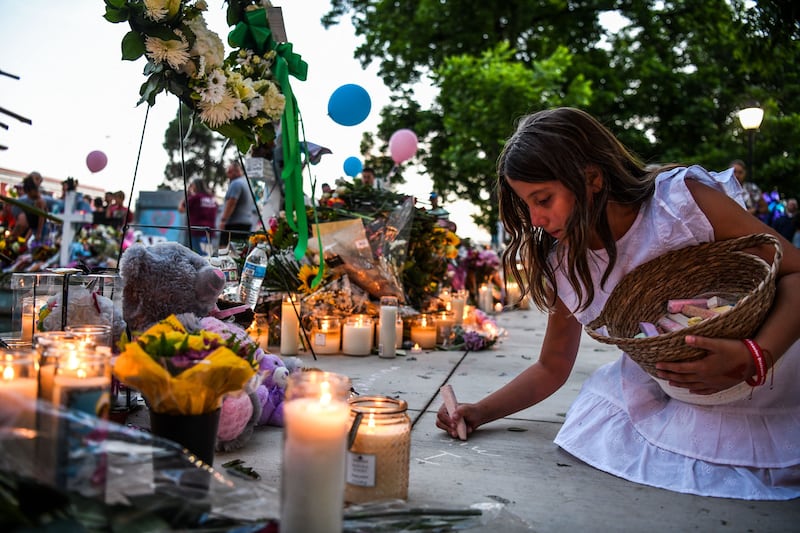 Alanna De Leon writes the name of her friend, Annabelle Rodriguez, who died in the shooting.  AFP