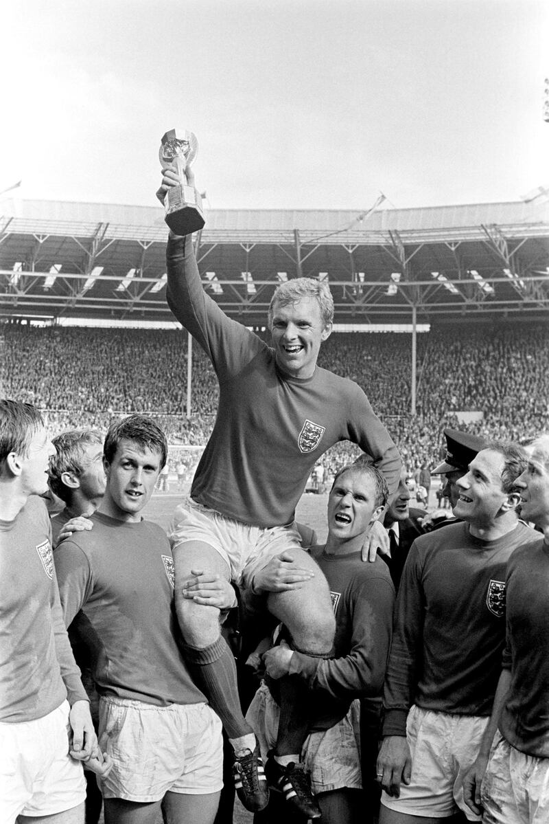 File photo dated 30-07-1966 of England's triumphant 1966 World Cup final captain Bobby Moore chaired by hat-trick hero Geoff Hurst (left) and Ray Wilson as he salutes the crowd with the Jules Rimet Trophy after the 4-2 victory against West Germany at Wembley. PA Photo. Issue date: Wednesday November 13, 2019. That unforgettable day at Wembley over 53 years ago remains England's solitary World Cup triumph.  See PA story SOCCER England Memorable. Photo credit should read PA/PA Wire.