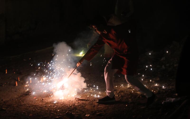 Indians light firecrackers near New Delhi. EPA