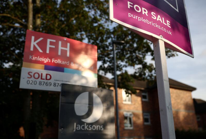 Estate agent signs in London. The average house price in the UK stood at £289,099 in May. Reuters