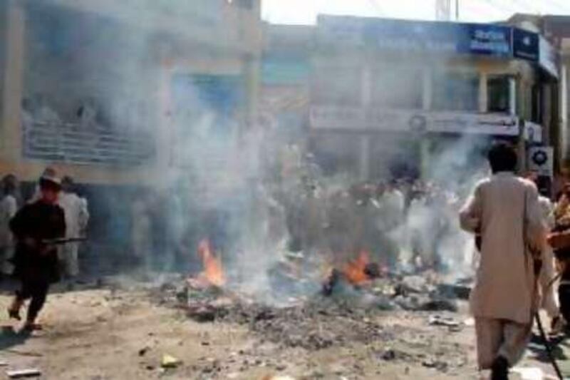 Pakistani protesters burn tyres on a road after police fired at the protesters in Mingora, the main city in Swat on September 23, 2008. Pakistani police shot dead five people in the volatile northwestern Swat Valley during a protest on September 23 against the alleged killing of children in a military operation.  AFP PHOTO/Imran ALI *** Local Caption ***  333509-01-08.jpg