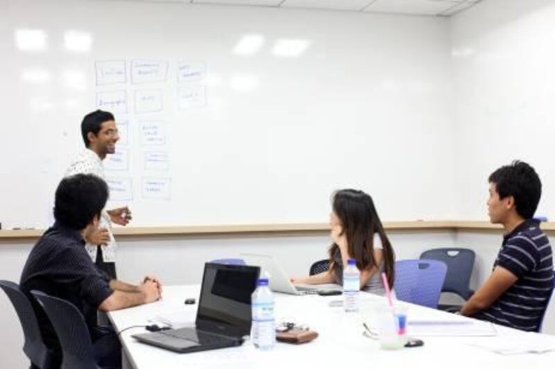 April 9, 2012, Abu Dhabi, UAE:

Left to right: Muhammad Awais Islam, Madhav Vaidyanathan, Songyishu Yang, and Ruey Ting Chien make up a team of NYU Students participating in the Hult Global Case Challenge. The purse is 1 million dollars which they hope to use to help an NGO called Solar Aid. 

They're coach is none other than the National's Neil Parmer. They're seen here inside of a study room, located in Sama tower, during a brainstorming session.

Lee Hoagland/The National