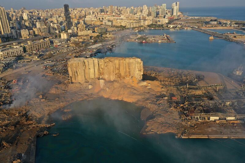 FILE - In this Aug. 5, 2020 file photo, smoke rises after an explosion the day before at the seaport of Beirut, Lebanon. Lebanese judicial officials say Lebanon has received on Monday, May 31, 2021, a "preliminary report" from France regarding last year's massive port blast in Beirut that killed and wounded many. (AP Photo/Hussein Malla, File)