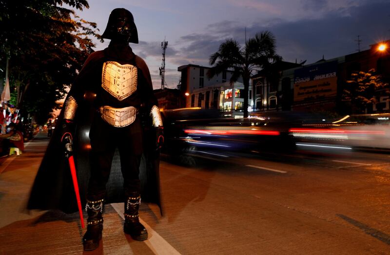 A person dressed as 'Star Wars' villain Darth Vader stands near a gathering of supporters of anti-government protest leaders charged with lese majeste – insulting the monarch – waiting for their release, in Bangkok, Thailand. Reuters