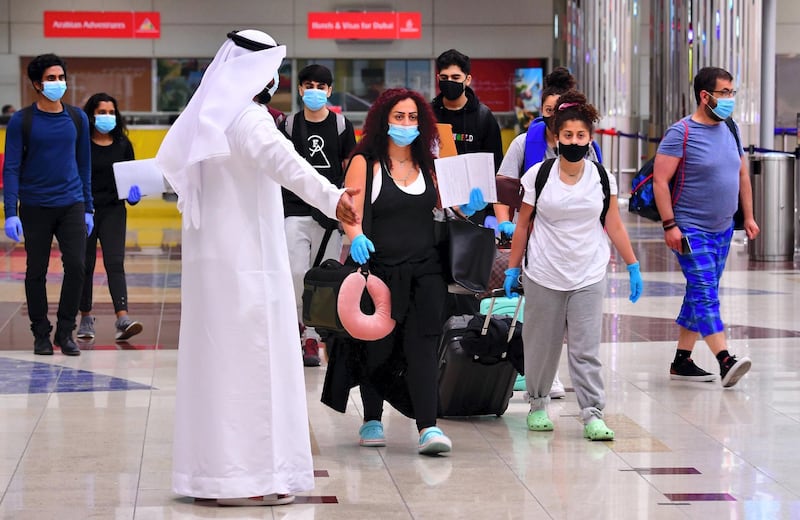 Tourists arrive at Dubai airport in the United Arab Emirates on July 8, 2020, as the country reopened its doors to international visitors in the hope of reviving its tourism industry after a nearly four-month closure. (Photo by GIUSEPPE CACACE / AFP)