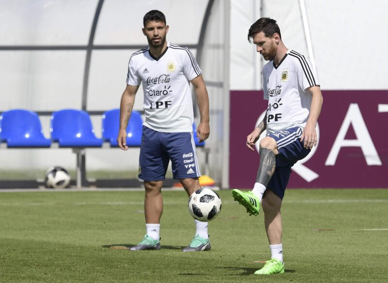 Lionel Messi passes the ball next to teammate Sergio Aguero during a training session at the team's base camp in Bronnitsy, on June 25. Juan Mabromata / AFP