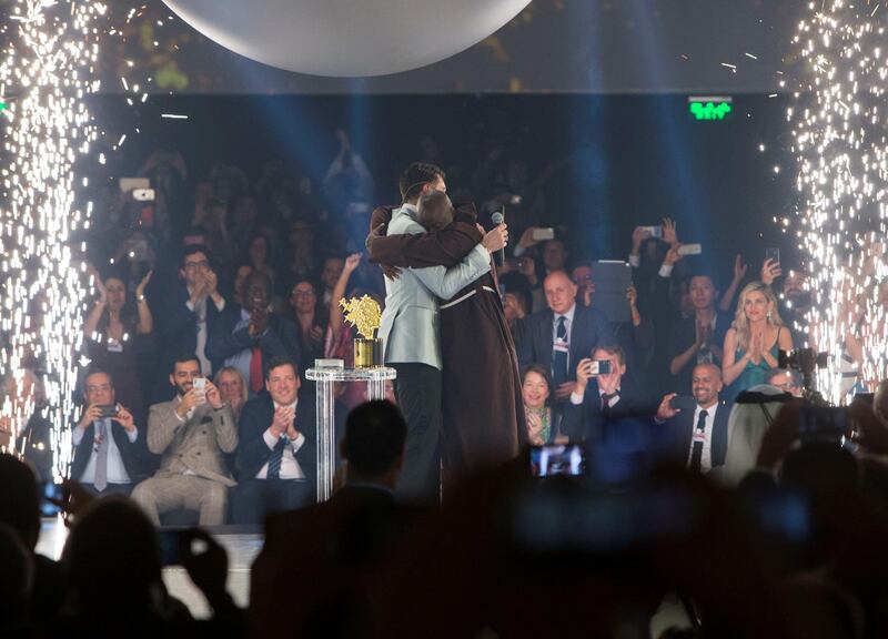 DUBAI, UNITED ARAB EMIRATES - Winner of the Global Teacher Prize 2019 Peter Tabichi from Kenya with actor Hugh Jackman and the teacher finalist at the Global Education and Skills Forum 2019 at Atlantis, The Palm.  Leslie Pableo for The National for Anam Rizvi's shorty