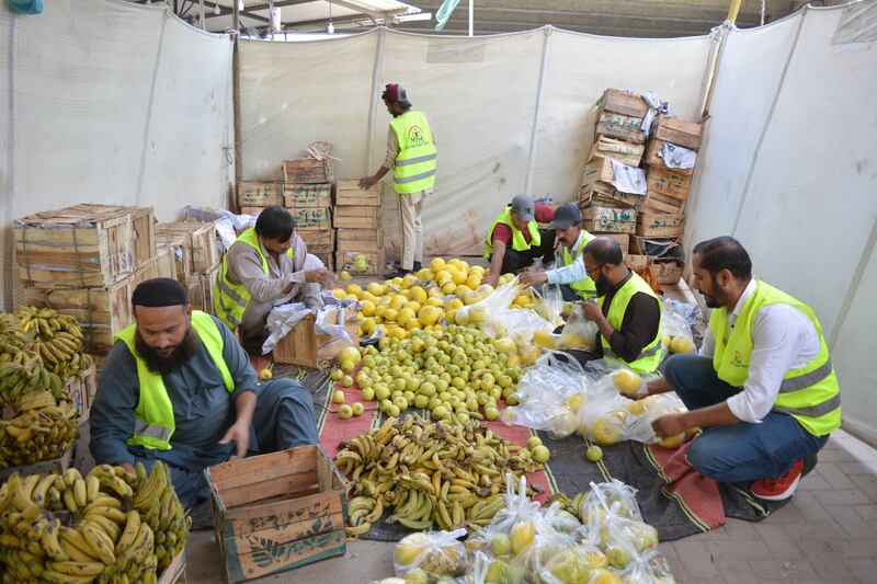 Volunteers sort the fruit