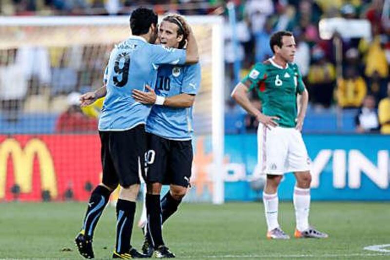 Luis Suarez, left, and Diego Forlan have combined well for Uruguay in the World Cup.
