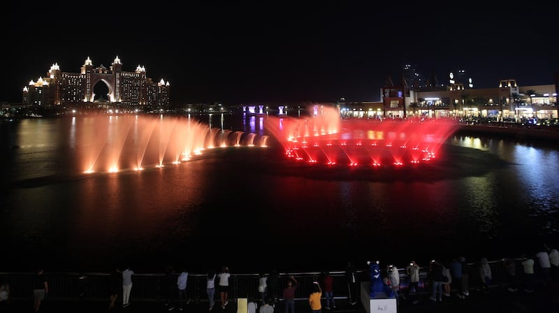 People watch the Palm fountain at the Pointe in Palm Jumeirah manmade island as a performance to celebrate the UAE's 49th National Day in Dubai United Arab Emirates.  EPA