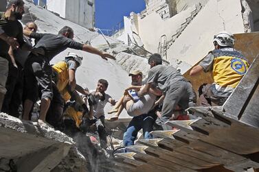 White Helmet rescue volunteers and civilians rescue a child from the rubble of a building destroyed during an air strike by Syrian regime forces and their allies on the town of Ariha, in the southern outskirts of Syria's Idlib province on May 27, 2019. AFP