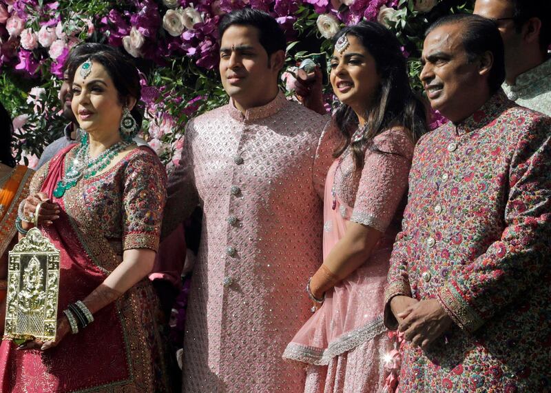 Reliance Industries Chairman Mukesh Ambani, right, his wife Nita Ambani, left, son Akash Ambani and daughter Isha arrive for Akash's wedding in Mumbai, India. Photo: AP