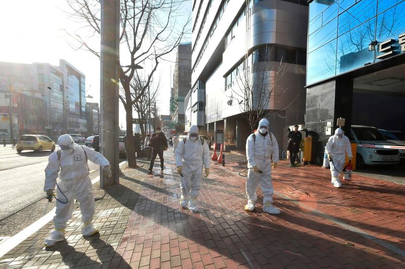 This handout picture taken on February 19, 2020 by Daegu Metropolitan City Namgu shows South Korean health officials wearing protective suit and spraying disinfectant in front of the Daegu branch of the Shincheonji Church of Jesus in the southeastern city of Daegu as about 40 new cases of the COVID-19 coronavirus confirmed after they attended same church services. A cluster of novel coronavirus infections centred on a cult church in the South Korean city of Daegu leaped to 39 cases February 20, as the country's total spiked for the second successive day. - RESTRICTED TO EDITORIAL USE - MANDATORY CREDIT "AFP PHOTO / Daegu Metropolitan City Namgu" - NO MARKETING NO ADVERTISING CAMPAIGNS - DISTRIBUTED AS A SERVICE TO CLIENTS


 / AFP / Daegu Metropolitan City Namgu / Handout / RESTRICTED TO EDITORIAL USE - MANDATORY CREDIT "AFP PHOTO / Daegu Metropolitan City Namgu" - NO MARKETING NO ADVERTISING CAMPAIGNS - DISTRIBUTED AS A SERVICE TO CLIENTS


