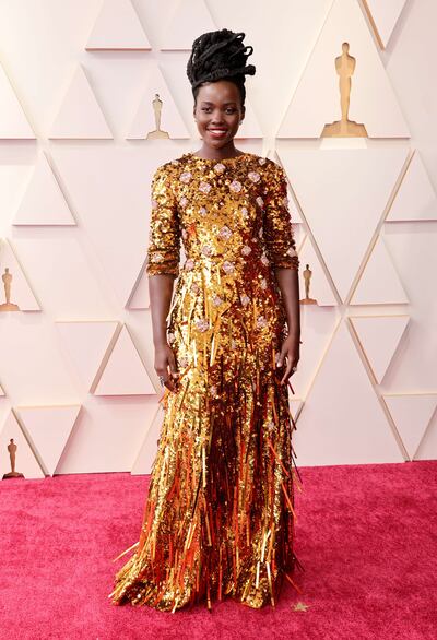 Lupita Nyong'o, wearing golden Prada, attends the 94th Annual Academy Awards on March 27, 2022 in Hollywood, California. Getty Images 
