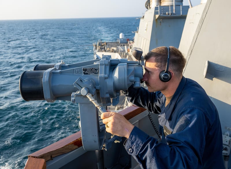 Boatswain's Mate 3rd Class Brent Cavalier looks through binoculars aboard the guided-missile destroyer USS Mason while the ship operates in support of Operation Prosperity Guardian in the Red Sea. Photo: US Navy
