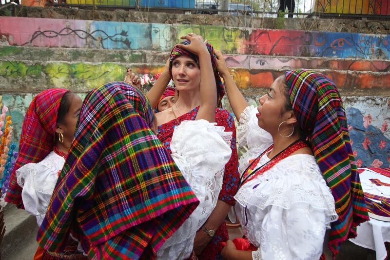 Jennifer Siebel Newsom, wife of California Governor Gavin Newsom, has a traditional Panchimalco shawl placed on her during a visit to Panchimalco, El Salvador. AP Photo
