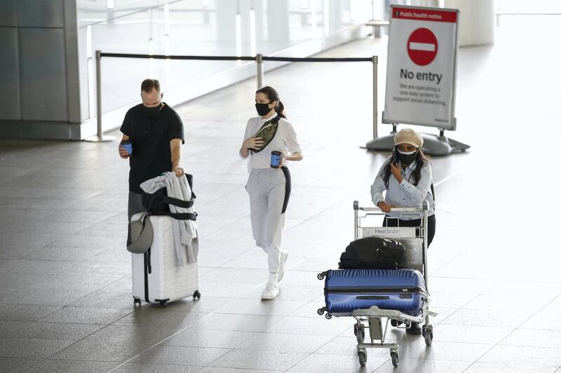 LONDON, ENGLAND - AUGUST 22: Travellers exit Heathrow Airport Terminal 2 on August 22, 2020 in London, England. As of Saturday morning at 4am, travellers arriving in England from Austria, Croatia, and Trinidad and Tobago were required to quarantine themselves for 14 days. At the same time, travellers from Portugal were no longer required to quarantine. (Photo by Hollie Adams/Getty Images)