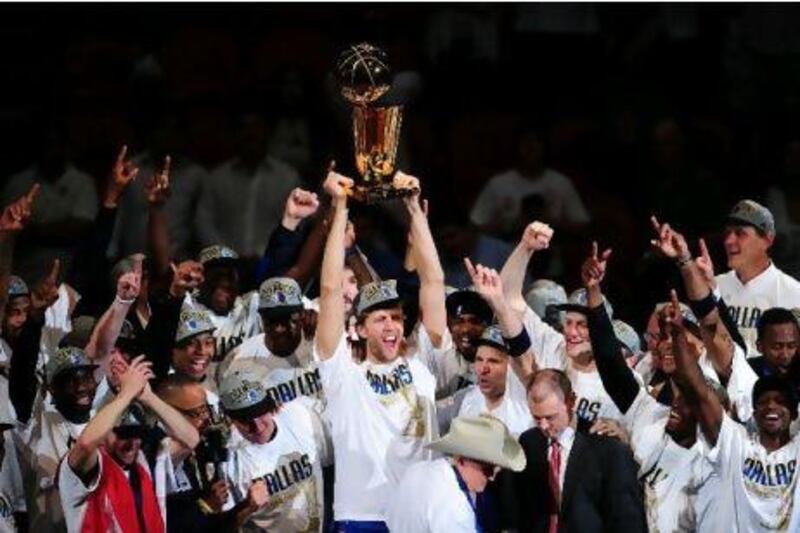 Dirk Nowitzki, cente, of the Dallas Mavericks celebrates with teammates after winning the NBA Finals.