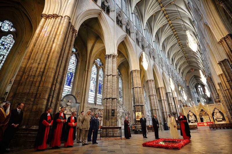 Britain's Prince Andrew, Duke of York (4R) and Dean of Westminster John Hall (R) look on as Emirati President Sheikh Khalifa bin Zayed al-Nahayan (2R) lays a wreath on the tomb of the Unknown Warrior in Westminster Abbey in central London on May 1, 2013 on the second day of his state visit to Britain. The UAE president was to face questions from Prime Minister David Cameron during a meeting over allegations that three British men jailed in Dubai were tortured. AFP PHOTO / BEN STANSALL
 *** Local Caption ***  027849-01-08.jpg