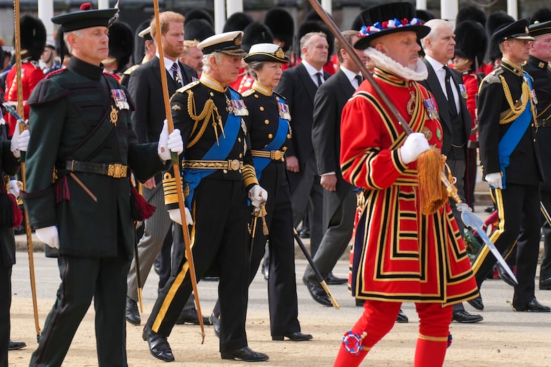 King Charles walks with Princess Anne, Prince Harry and Prince Andrew behind the coffin of Queen Elizabeth as it is pulled on a gun carriage through the streets of London following her funeral service. AP 