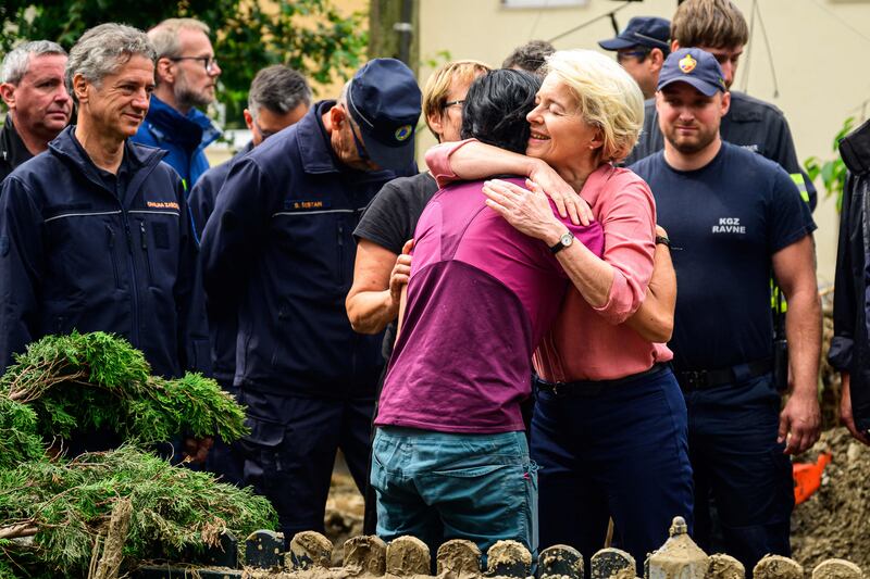 EU Commission President Ursula von der Leyen embraces a resident of Crna na Koroskem as she visits flood-hit areas of Slovenia. AFP