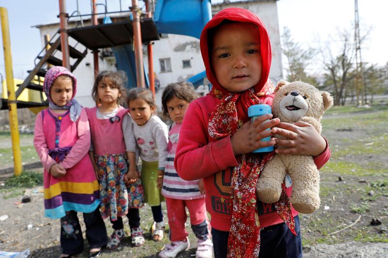 Afghan migrant children pose as they play in front of their homes in Kars, eastern Turkey. Umit Bektas / Reuters