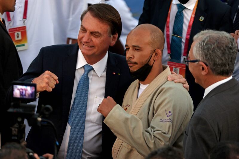 Brazil's President Jair Bolsonaro with a participant in the world's largest jiu-jitsu training session at the Brazil pavilion at Expo 2020 Dubai. AFP