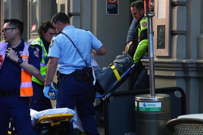 A woman is placed onto a gurney by paramedics in Sydney, Australia.  EPA
