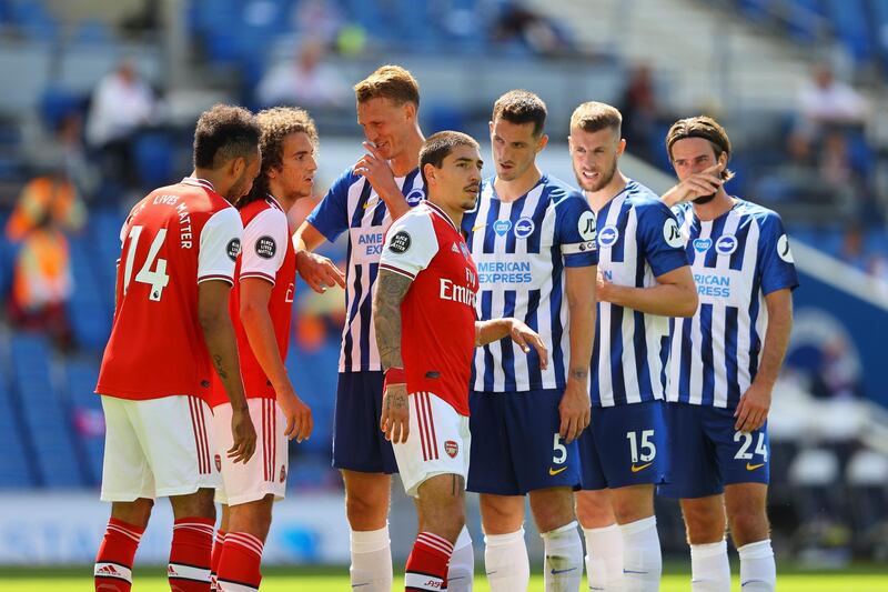 Arsenal and Brighton players wait for a corner on Saturday. EPA