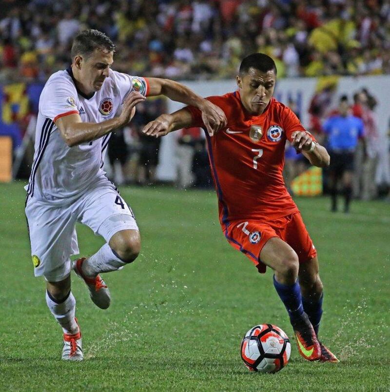 Santiago Arias #4 of Colombia and Alexis Sanchez #7 of Chile chase the ball during a semi-final match in the 2016 Copa America Centernario at Soldier Field on June 22, 2016 in Chicago, Illinois. Chile defeated Colombia 2-0. Jonathan Daniel/Getty Images/AFP