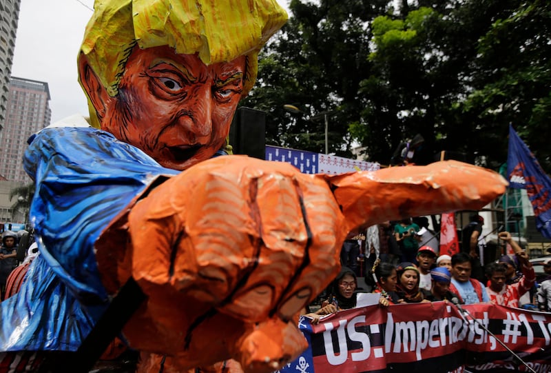 Protesters beside an effigy of US president Donald Trump as they tried to march towards the US embassy in Manila. Aaron Favila / AP Photo