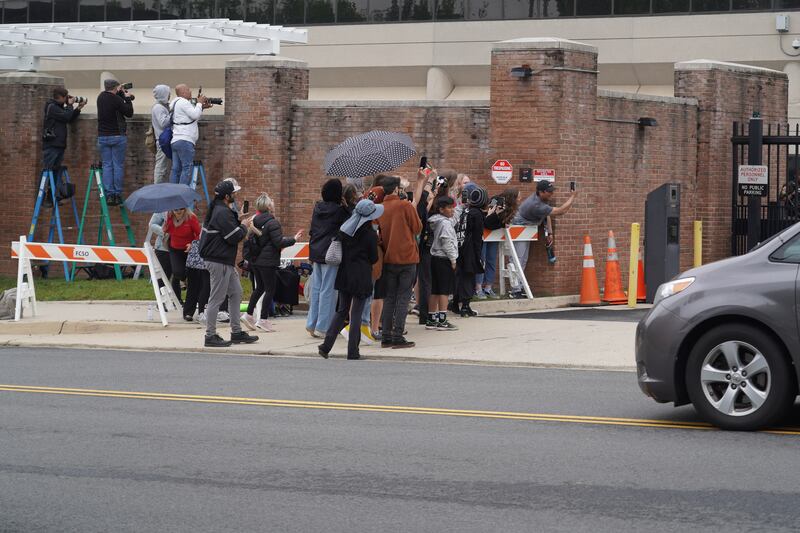 Fans of actor Johnny Depp try to take his picture through a gate at the courthouse. Willy Lowry / The National