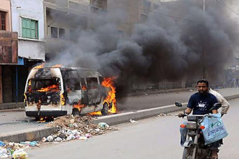 More than 100 people were wounded and dozens of vehicles and shops torched as mobs took to the streets in Karachi.