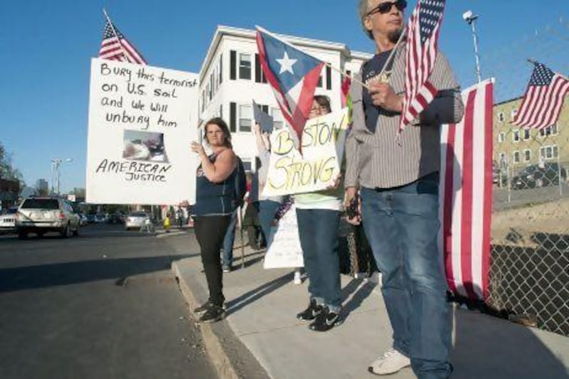 Lisa Taurasi, Lucy Rodriguez and Luis Barbosa, all of Worcester, protest outside Graham Putnam & Mahoney Funeral Parlors in Worcester. They do not want Tamerlan Tsarnaev buried in the United States.