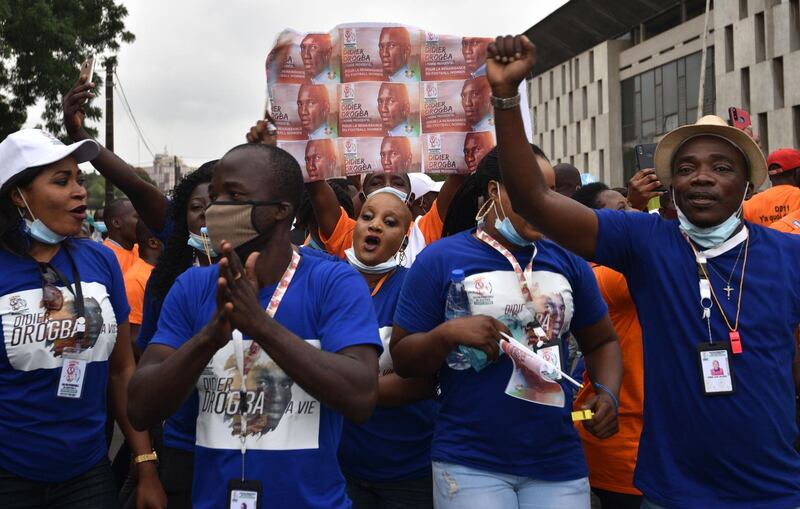 Supporters hold a banner bearing Drogba's portrait. AFP