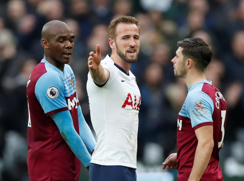 Tottenham Hotspur's Harry Kane speaks with West Ham United's Aaron Cresswell and Angelo Ogbonna. Reuters
