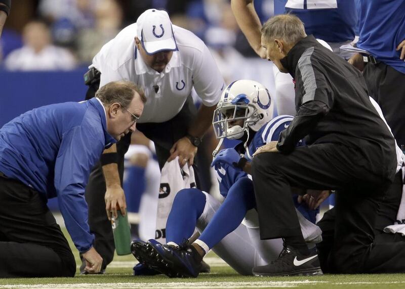 Trainers tend to Indianapolis Colts wide receiver Reggie Wayne after he injured his knee last week. AJ Mast / AP Photo