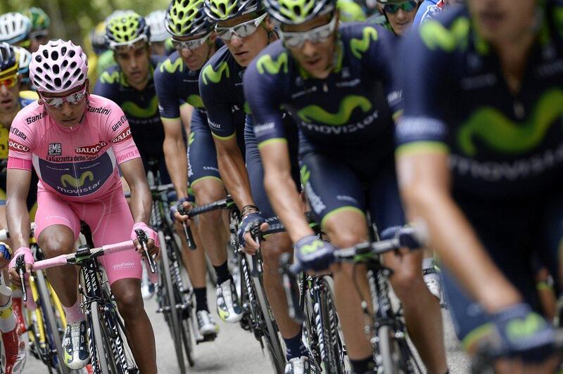 Colombia's Nairo Quintana, left, shown in the pink leader's jersey during the second-to-last stage of the 2014 Giro d'Italia on Saturday. Barring disaster, he finished the stage in commanding position to win his first Grand Tour on Sunday. Fabio Ferrari / AP / May 31, 2014