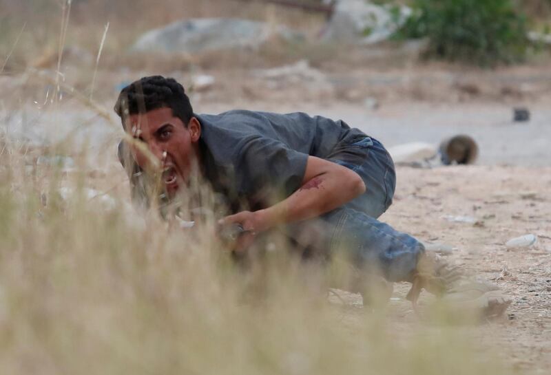 A GNA troop tries to get the attention of a fellow fighter during the battle. Reuters