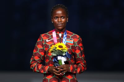 Silver medallist Brigid Kosgei of Kenya celebrates on the podium in Tokyo. Reuters