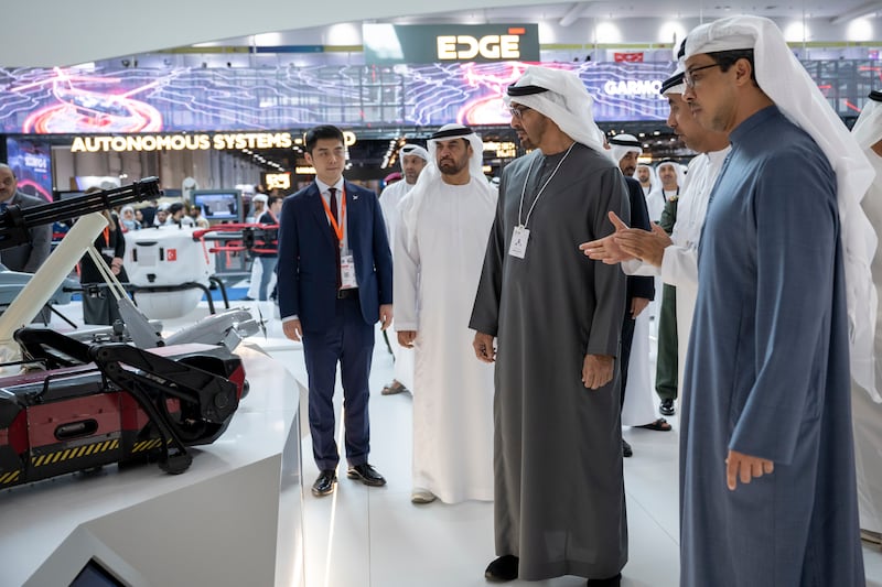 Sheikh Mohamed and Sheikh Mansour view an exhibit at a booth