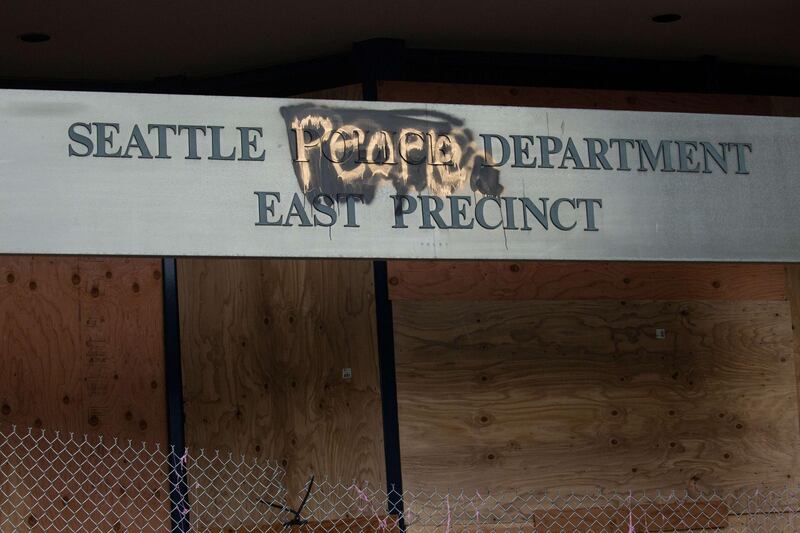 A defaced sign with "people" painted over "police" is seen on the exterior of the Seattle Police Departments East Precinct in the so-called "Capitol Hill Autonomous Zone." Getty Images/AFP