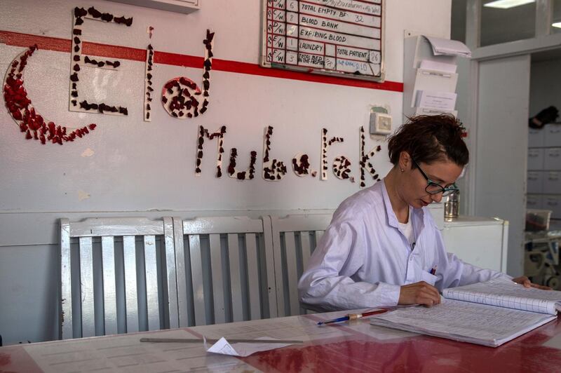 Nurse Elisa Venturella counts last week's admissions at the hopsital: a total of 95, including 28 patients from this week's attacks in Kabul. On the wall, a rose petal-decorated "Eid Mubarak" greets the new patients. 