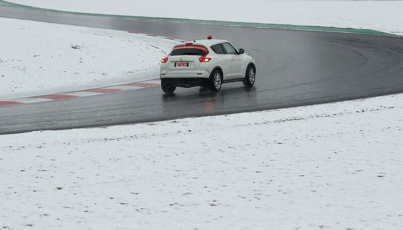 Race control check the track surrounded by snow before testing. Albert Gea / Reuters