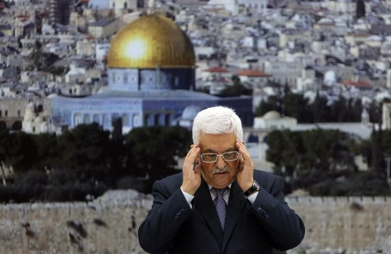Palestinian president Mahmoud Abbas recites a prayer in memory of those killed during the Israeli military offensive on the Gaza Strip, ahead of an announcement that a truce had been reached on August 26, 2014. Abbas Momani/AFP Photo